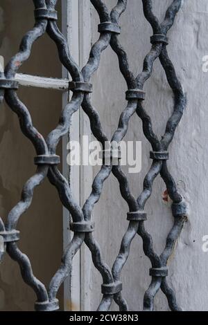 Forged lattice structure as a screen or fence for window protection in old monastery. Stock Photo