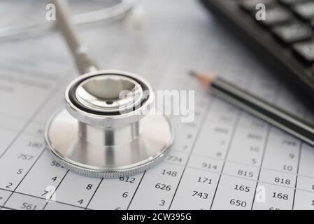 medical billing,  stethoscope and calculator on bills for health care costs or medical insurance. Stock Photo