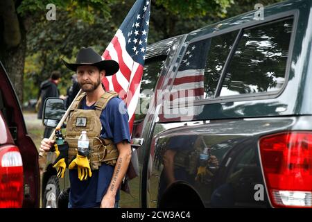 Portland, USA. 26th Sep, 2020. Left and right wing demonstrators clash in Delta Park on September 26, 2020 in Portland Oregon. Western chauvinists that engage in political violence, The Proud Boys, are known for disseminating misinformation and having contentious and violent confrontations with the antifascist group Eugene Antifa. This alternate location to downtown Portland is located in the grater area, once the site of Vanport City that was wiped out by floods in 1948. (Photo by John Lamparski/SIPA USA) Credit: Sipa USA/Alamy Live News Stock Photo