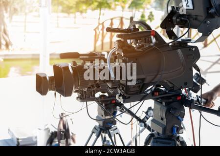 The cameraman is on duty and two camera lenses for broadcast are focused on the program guests Stock Photo