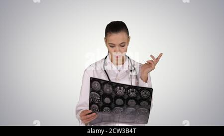 Doctor female with white labcoat, looking at x-ray radiographic Stock Photo