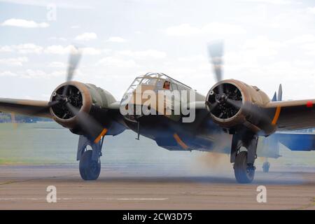 A Bristol Blenheim light bomber clouded in smoke during engine start at Abingdon Air & Country Show, Oxfordshire, UK Stock Photo