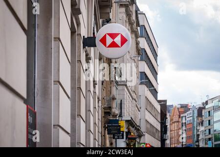 LONDON, ENGLAND - JULY 24, 2020: HSBC Bank plc signboard logo affixed to the wall of a branch on the High Street at Holborn, London  - 012 Stock Photo