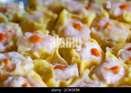 Shumai is a type of traditional Chinese dumpling, originating from Hohhot. In Cantonese cuisine, it is usually served as a dim sum snack. Stock Photo