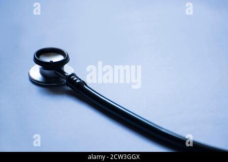 Part of stethoscope isolated on blue background Stock Photo