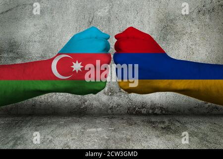 Concept of the Conflict between Armenia and Azerbaijan with two opposing fists in front of a wall Stock Photo