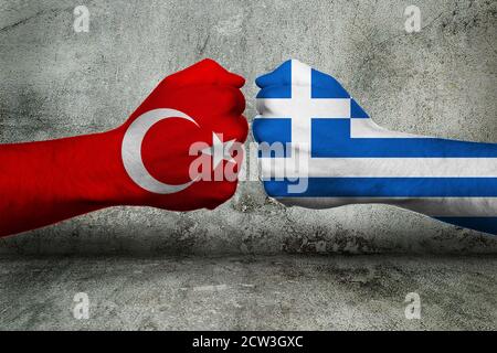 3D Illustration of a Concept of the Conflict between Greece and Turkey with two opposing fists in front of a wall. 3D rendering Stock Photo
