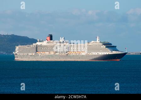 Weymouth, Dorset, UK.  27th September 2020.  The empty Cunard cruise ship Queen Victoria at anchor on a sunny morning in Weymouth Bay off the coast of Weymouth in Dorset during the cruising shutdown because of Covid-19. Picture Credit: Graham Hunt/Alamy Live News Stock Photo