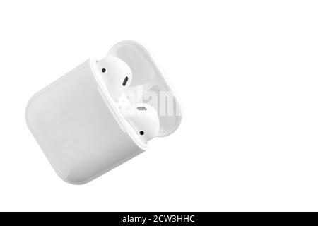 White headphones wireless earphones with case, copy space isolated background Stock Photo