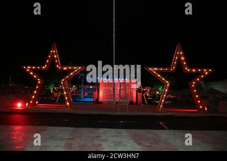 Big illuminated decorative star lamp standing outdoor on floor with beautiful back lights at an event , night time exposure Stock Photo