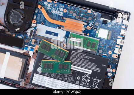 Image depicting an open laptop computer with memory or RAM sticks ready to upgrade the internal memory to improve speed Stock Photo