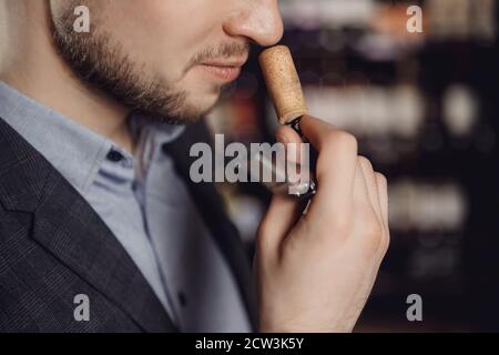 Smell of wine cork in hands of sommelier, sample aging drink Stock Photo