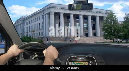 Driving a car towards the facade of the Martynas Mažvydas National Library, Vilnius, Lithuania Stock Photo