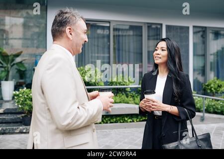 Colleagues talking outdoors Stock Photo