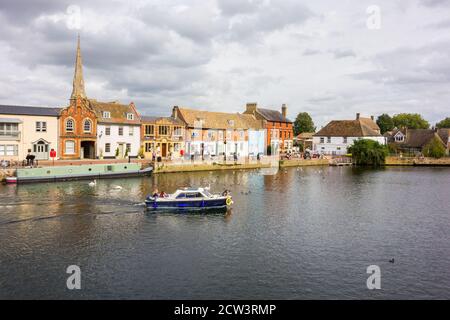 Narrowboat and pleasure craft against the quayside on the river great Ouse at St Ives Cambridgeshire England