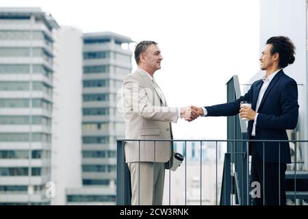 Positive entrepreneurs shaking hands Stock Photo