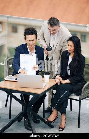 Business team discussing finance data Stock Photo