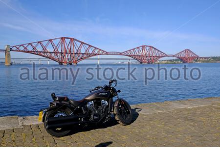 South Queensferry, Scotland, UK. 27th Sep 2020. Distinguished Gentleman’s Ride unites classic and vintage style motorcycle riders all over the world to raise funds and awareness for prostate cancer research and men’s mental health. A themed ride astride a classic bike and wearing fine suits, connecting niche motorcycle enthusiasts and communities while raising funds to support mens health. Seen here in front of the Forth Bridge. Indian Scout Bobber motorcycle. Credit: Craig Brown/Alamy Live News Stock Photo