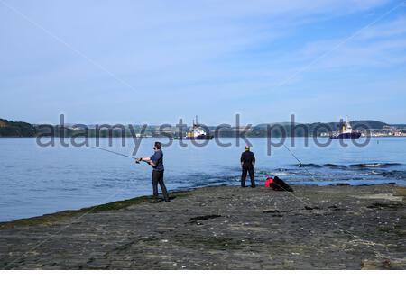 South Queensferry, Scotland, UK. 27th Sep 2020. Fine weather brings out the visitors to South Queensferry. Fishing from the pier in the Forth Estuary. Credit: Craig Brown/Alamy Live News Stock Photo