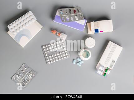 Various medicine bottles and different pills blister pack on grey background Stock Photo