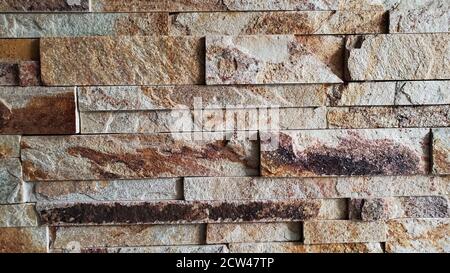 Rough stone brick wall texture with copy space. Architecture tiled surface closeup. Masonry wall background. Neutral color building finishing Stock Photo