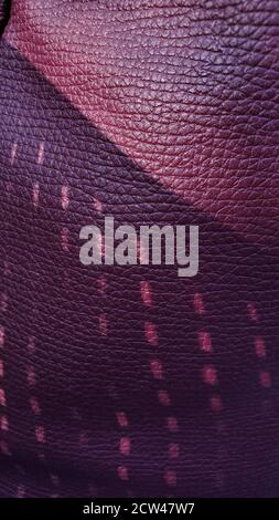 Dark purple background of artificial leather material with wrinkled pattern and dotted shadows. Geometric patterns closeup Stock Photo