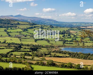 Llangors Lake or Llyn Syfaddan in the Black Mountains of Wales with Pen y Fan in the far distance Stock Photo