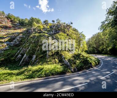 Cyclist climbing the steep road up through Burrington Combe in the