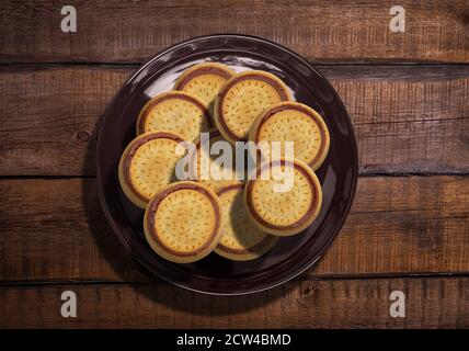 top view plate full of chocolate round biscuits or cookies Stock Photo