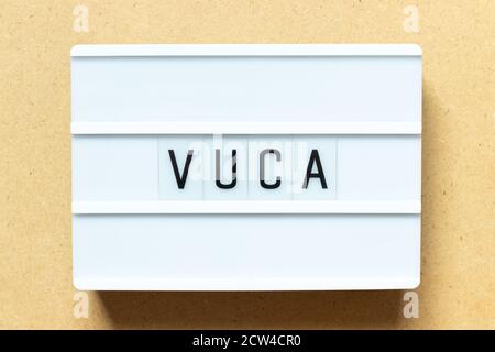 Lightbox with word VUCA (abbreviation of Volatility, uncertainty, complexity and ambiguity) on wood background Stock Photo