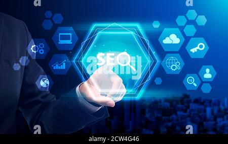 Unrecognizable Businessman Pressing Word Seo On Digital Screen, Blue Background Stock Photo