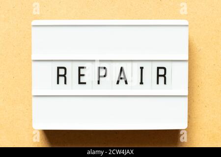 Lightbox with word repair on wood background Stock Photo
