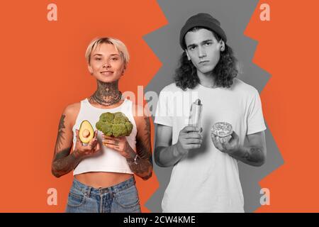 Young adult couple holding food in hands Stock Photo