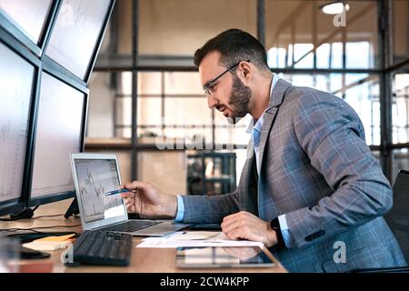 Confident businessman analyzing stat and dynamic on forex charts Stock Photo