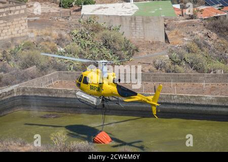 Helicopetor carrying water in firefighting tasks Stock Photo
