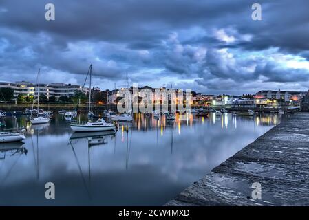 Dun Laoghaire harbor during the blue hour. West Pier. Evening shot of famous harbor in Dublin, Ireland Stock Photo