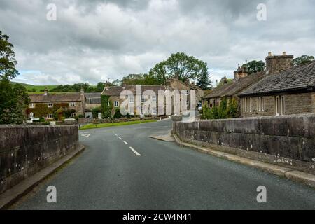 Burnsall village centre - street view of quaint houses from the bridge, Yorkshire Dales, UK Stock Photo