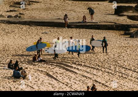 High perspective view of group of surfers in Ericeira, Portugal Stock Photo
