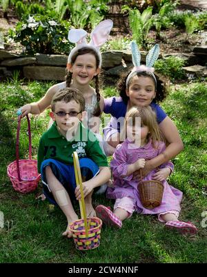 Kids pose for easter egg hunt photo. Stock Photo