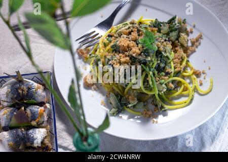 Sicilian recipe: 'Pasta ch'i sardi' (spaghetti with sardines and wild fennel) and seasoned sardine rolls called 'sardine a beccafico' Stock Photo