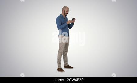 Casual arabic businessman using the phone and smiling on gradien Stock Photo