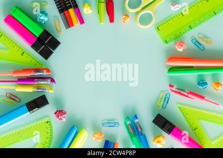 school and office items, colored pens, staples, markers, set squares, on a pastel glass. Empty space for text. Stock Photo