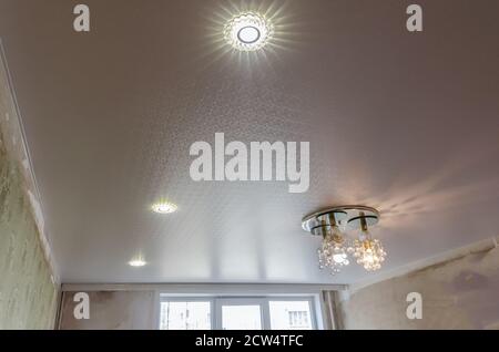 Ceiling in the room with spotlights installed and turned on Stock Photo