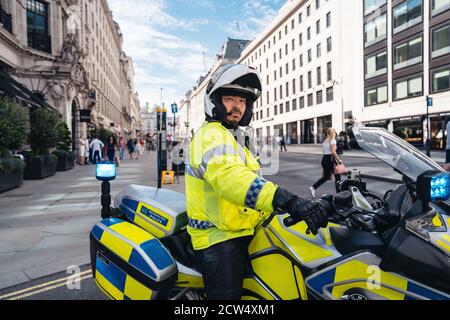 London / UK -  2020.07.18: Metropolitan Police Officers on motorbikes waiting for Black Lives Matters crowd protesters to pass. Stock Photo