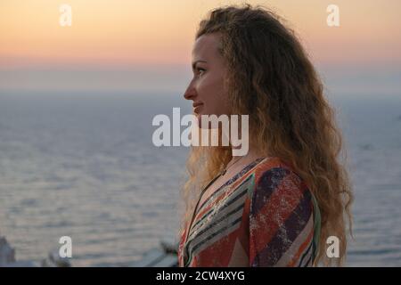 woman face looking at sunset and sea view from terrace of luxury holiday villa Stock Photo