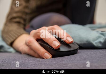 Close-up woman hand with mouse. Shallow depth of field. Selective focus. Stock Photo