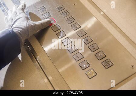 Hand presses the elevator button of the eleventh floor Stock Photo