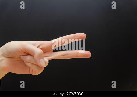 Female hand showing two fingers up in the peace, victory symbol or scissors. Isolated with clipping path. Stock Photo