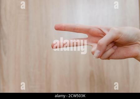 Female hand showing two fingers up in the peace, victory symbol or scissors. Isolated with clipping path. Stock Photo