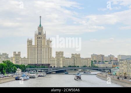 Moscow, Russia - May 30, 2019: View on Moskvoretskaya Embankment with traffic and skyscraper from floating bridge Stock Photo